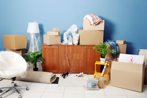 People preparing boxes for Collierswood removals in a home moving scene