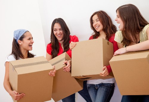 Professional movers carrying furniture through a flat entrance