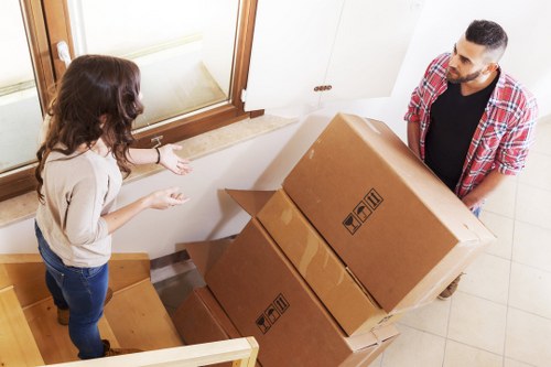 Removal crew separating reusable furniture and recyclable items during a clearance